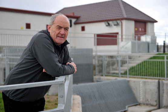 Forres councillor George Alexander beside the culvert which feeds water to the Pilmuir pumping station, behind him. Picture by Gordon Lennox.