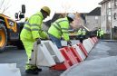 Aberdeenshire council workers put down flood prevention barriers