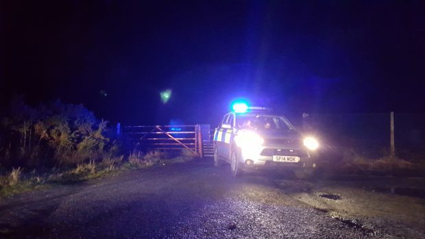 Police guarding the entrance to the firing range at Tain