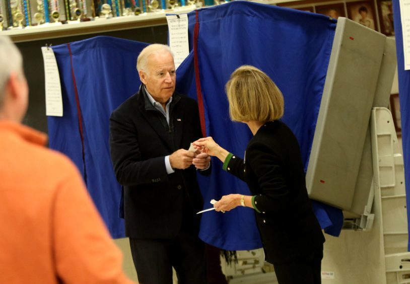 Vice President Joe Biden receives his "I Voted" sticker after casting his vote on Election Day.