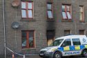 The cordoned off flat in Wick's Huddart Street, where a fire led to a mans arrest.