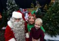 Santa Claus with Susan Crighton, fundraising manager at Clan and Adam Craik, 5, Portlethen. (Picture: Jim Irvine)