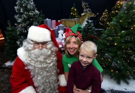 Santa Claus with Susan Crighton, fundraising manager at Clan and Adam Craik, 5, Portlethen. (Picture: Jim Irvine)