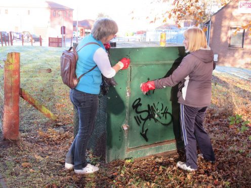 Volunteers remove graffiti in Culloden