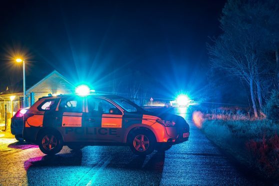 Police at the scene of the crash in Moray