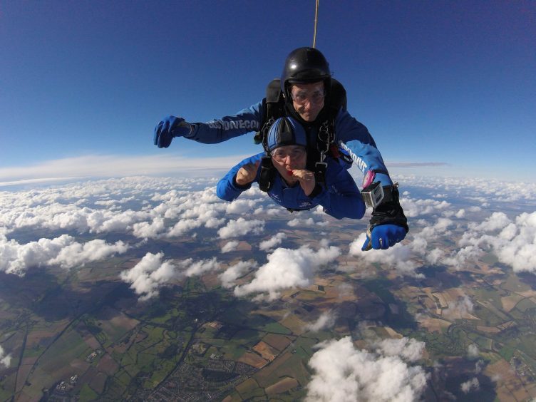 Martin Rees from the UK (in tandem with Ryan Mancey) as he achieves the Guinness World Record for the most magic tricks performed in a skydive, which is 11,.
