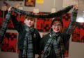 Archie Coull  and Aliyah Wilson with their tartan