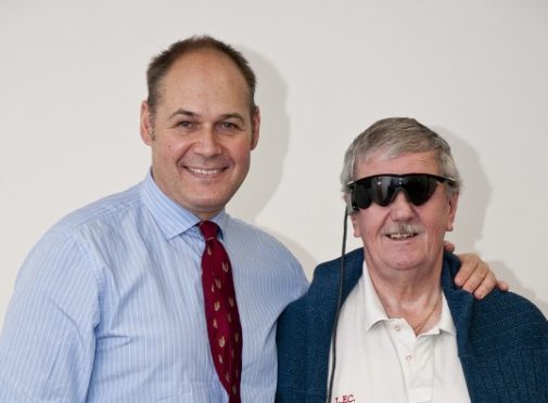 Keith Hayman (right), seen here with one of the implanting surgeons Professor Paulo Stanga, was one of the first to have the implant fitted