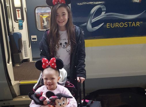 Eileidh Paterson and her sister Cerys wearing Minnie Mouse ears as they set off for Disneyland in France.