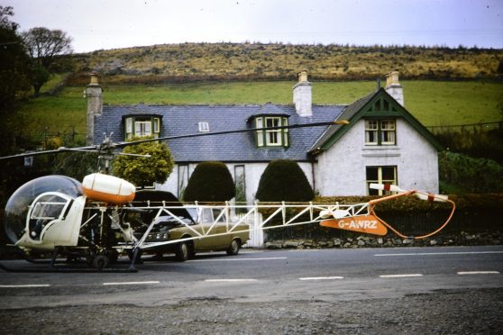 The Bell Type 47G helicopter  being jump started in Bellabeg, Strathdon, 1974.