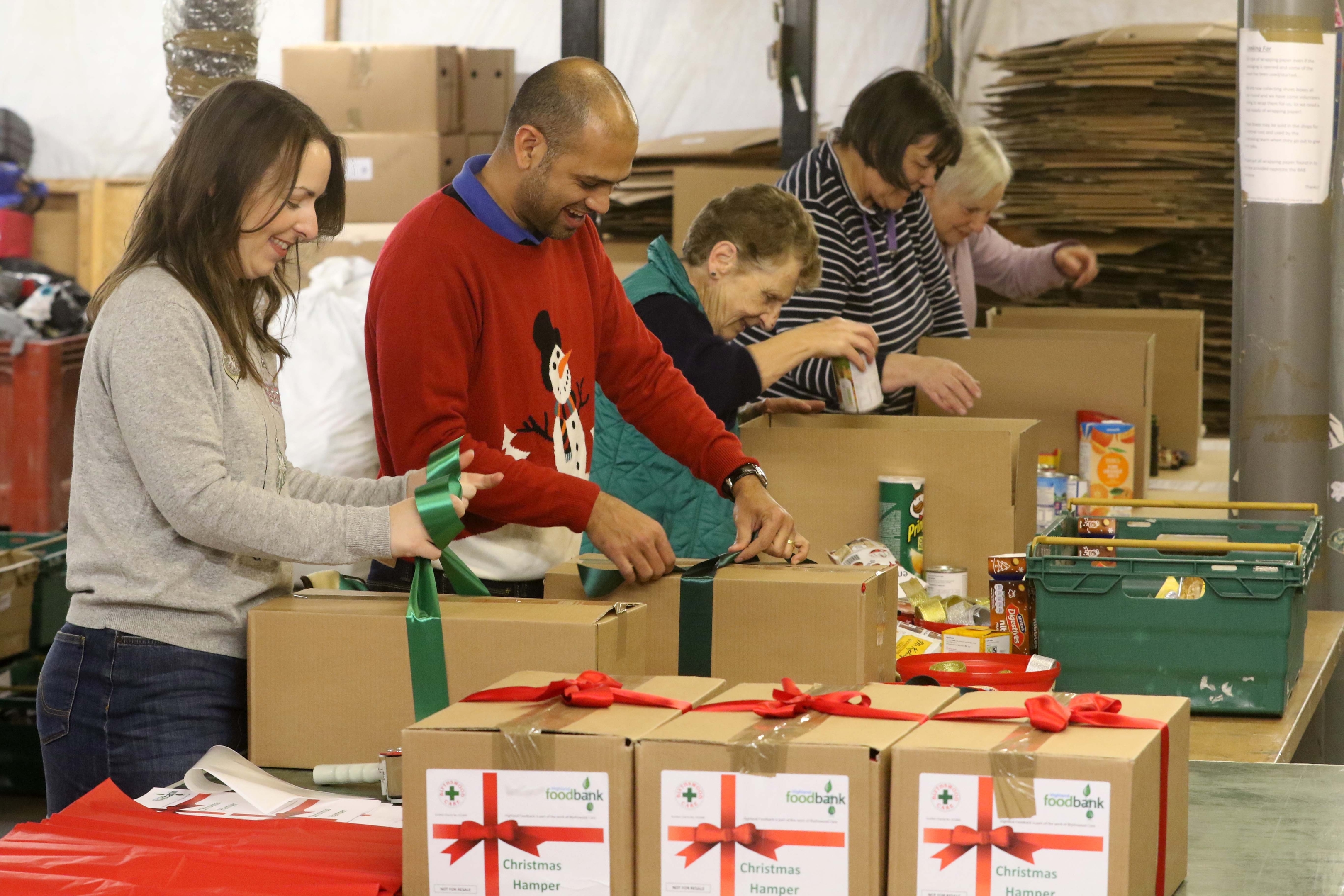 Blythswood staff and volunteers preparing Christmas food bank boxes. This pic, left-to-right: Blythswood food bank development officer Laura Ferguson, admin assistant Ebenezer Meiselbach, and volunteers Sheila MacLeod, Margaret Morrison and Val Dunford. 