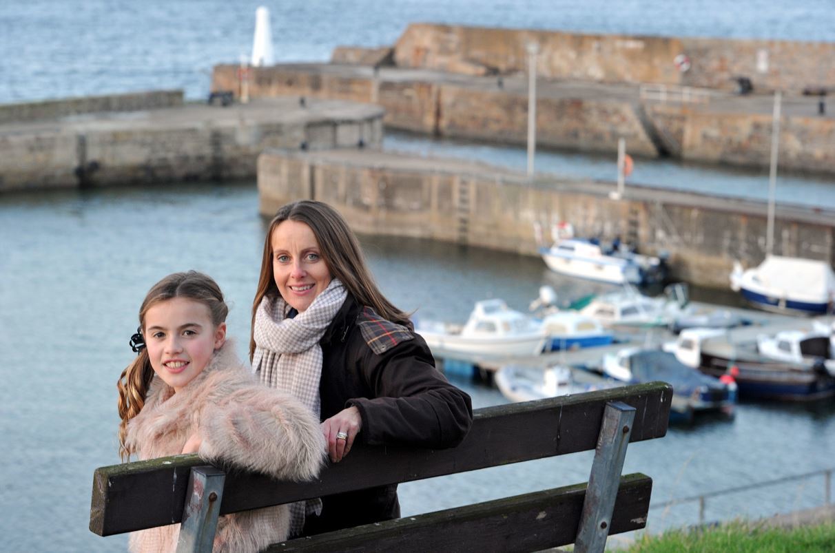Zara and Marie Gill overlooking Cullen Harbour, which features prominently in their poem.