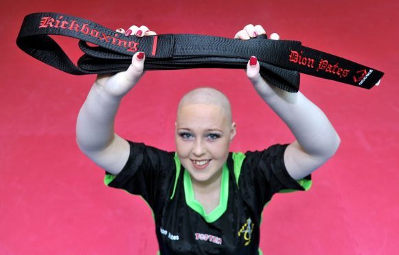 Teenage inspiration, Dion Yates, with the black belt she was awarded by Empower Martial Arts in Lossiemouth, in spite of her continued battle with cancer.