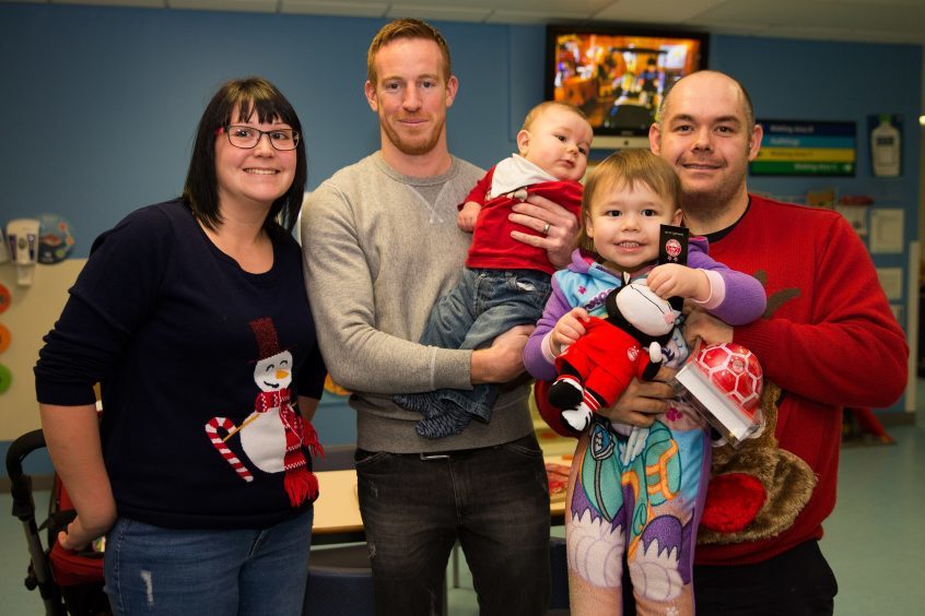 Owen Malcolm with striker Adam Rooney and dad Ian, mum Leanne and sister Ruby, 3.
