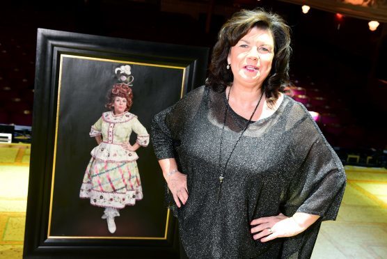 Elaine C Smith at HMT with her panto dame portrait  behind her