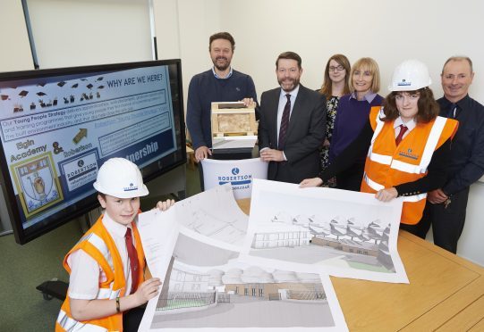 Pupils Edward Greenwood, Natasha Ogle and head teacher David Barnett (second from left) help launch the partnership with Robertson Group.