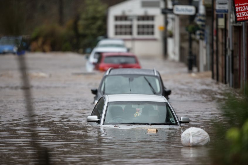 Cars submerged after the River Dee burst its banks