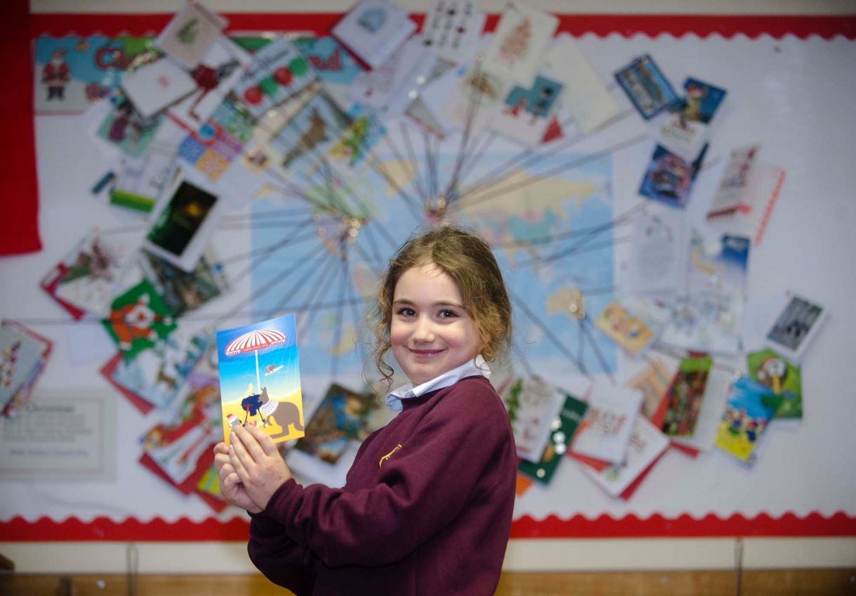 Glenlivet pupil Maisie Anthony, 7, in front of the classroom map showing where the cards have come from.