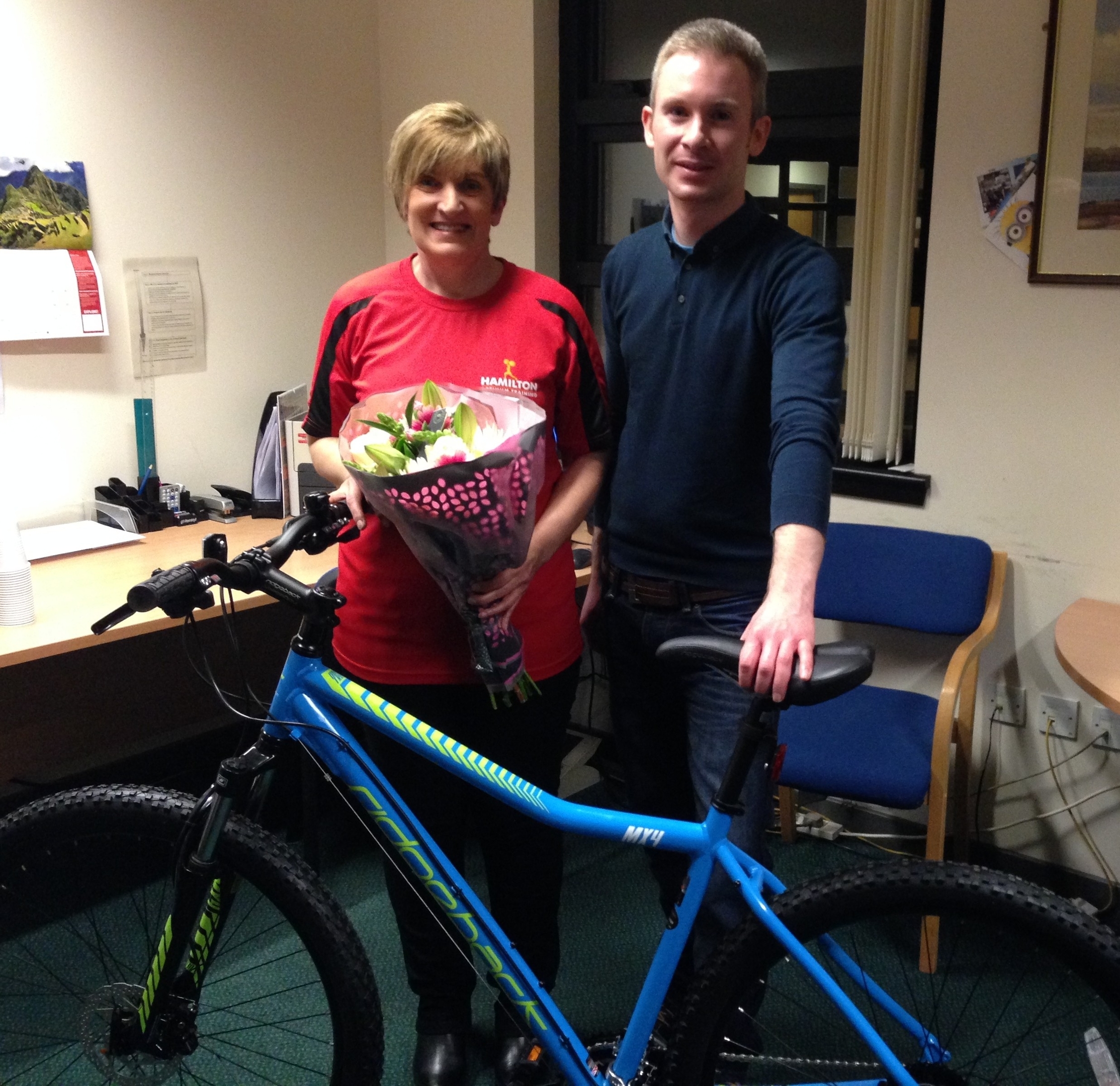 Jackie McKay and Stuart Hickie with the donated bike, just one of the many items that Jackie bought for the ward.