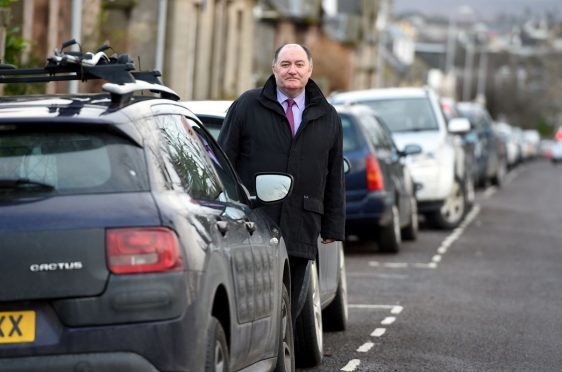 Elgin City South councillor John Divers intends to raise the problem of parking in the town's centre with police.