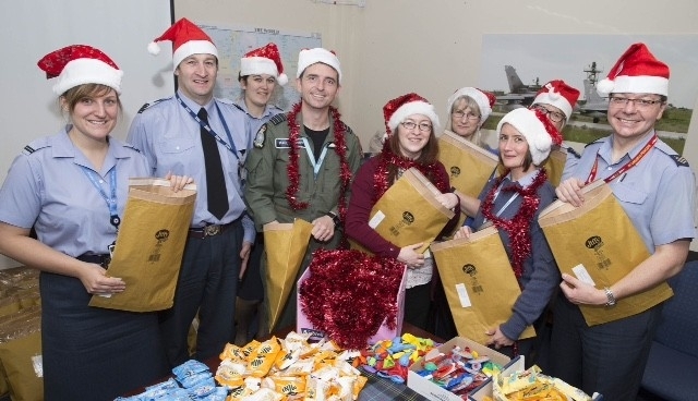 Station Commander of RAF Lossiemouth, Group Captain Paul Godfey helping pack festive welfare parcels which are being set to RAF Lossiemouth personnel who are serving overseas during the festive period.