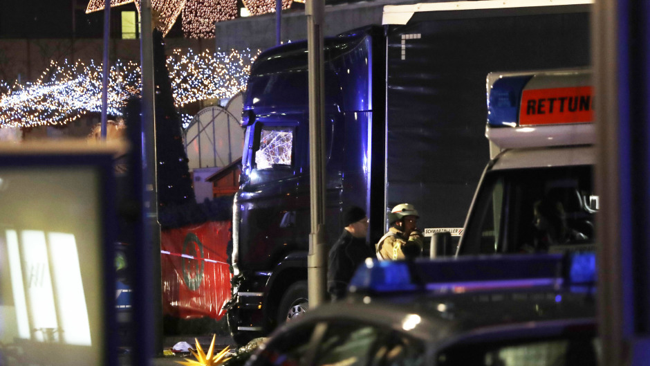 Police stand beside the damaged truck in Berlin (AP)