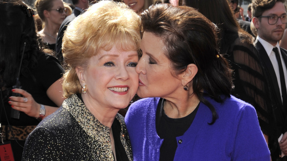 Debbie Reynolds, left, with her daughter Carrie Fisher at the Primetime Creative Arts Emmy Awards in Los Angeles in 2011 (AP)