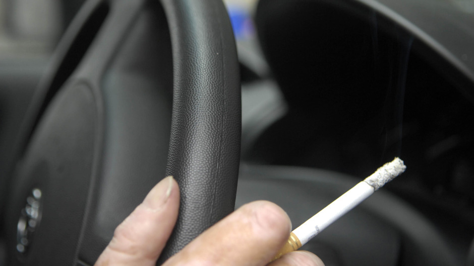 The law means anyone caught smoking in their car with children present will be fined.