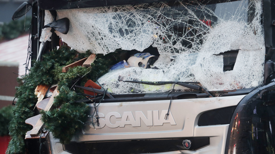 The smashed window of the cabin of a truck which ran into a crowded Christmas market in Berlin