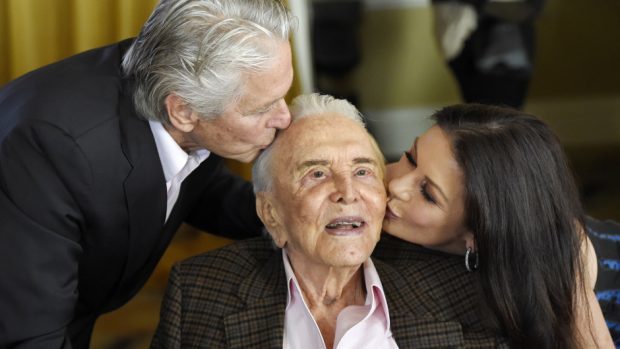 Kirk Douglas gets a kiss from his son Michael Douglas and daughter-in-law Catherine Zeta-Jones (Invision/AP)