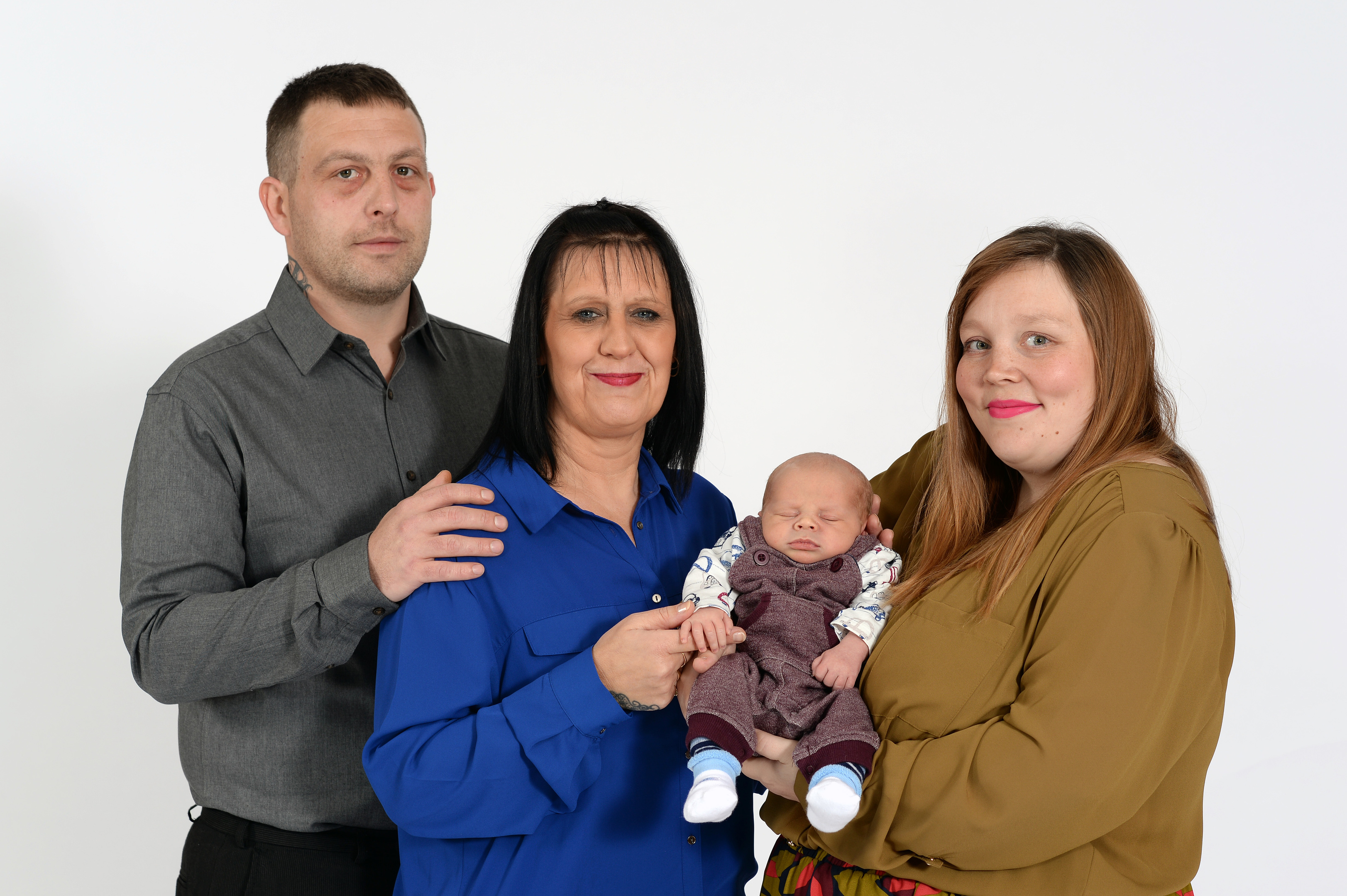 Benita and Mark Cutter with their surrogate baby Logan and surrogate mum Becky Harris