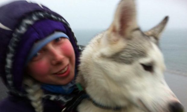 Rebecca pictured with one of her huskies (Image courtesy of Dundee Courier)