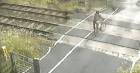 An image taken from CCTV of a cyclist coming within inches of being killed by a train (Network Rail/PA)