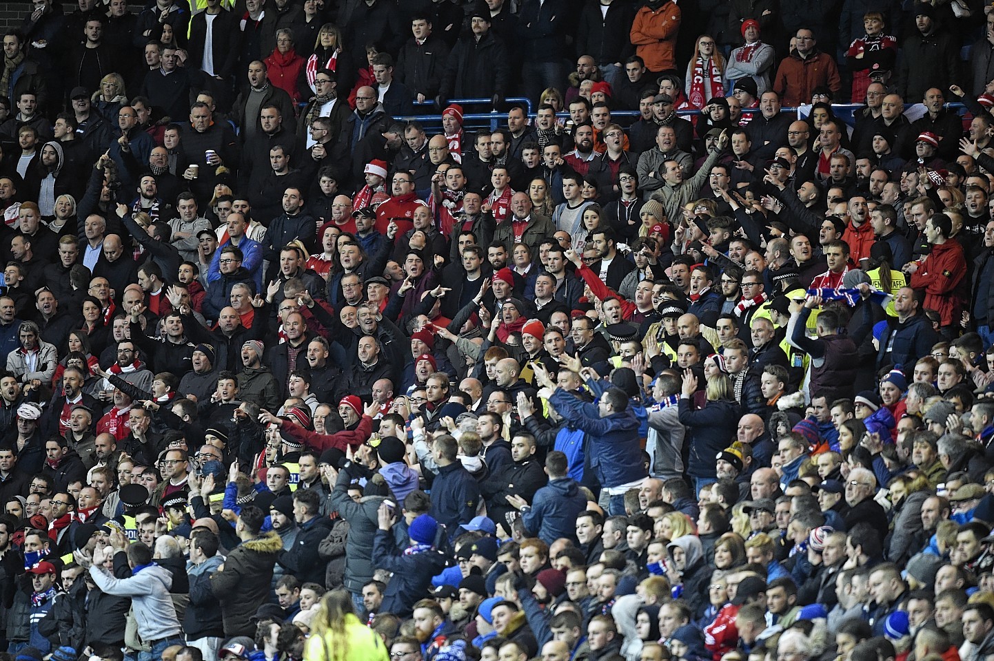 Fans are separated by police during the match