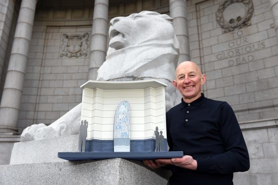 Artist Gordon Burnett. with a model of the Remembrance Hall statue