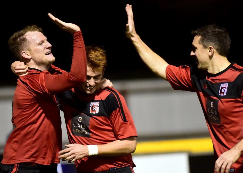 Loco's Ross Anderson (left) celebrates his goal  with Martin Laing and Neil McLean (right).