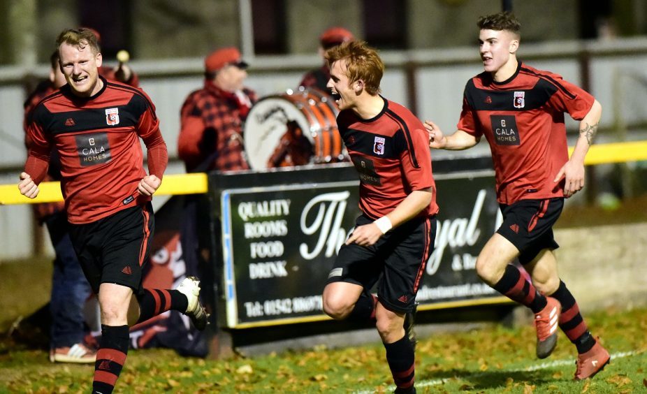 Loco's Ross Anderson (left) celebrates his goal (No1) with Martin Laing and Joseph McCabe (right).