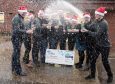 From left to right: Graeme Lacey, Bruce Richards, Darren Graham, Gareth Dack, John Cunningham, Philip Souter, Colleen Mallis, Louise Robertson, Gail Brown and Stephen Robertson, some of the 16 ventilation workers who won £1 million in a lottery syndicate.