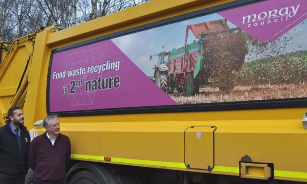 Councillor John Cowe and waste monitoring officer Mike Neary view one of the vehicle-mounted recycling messages.