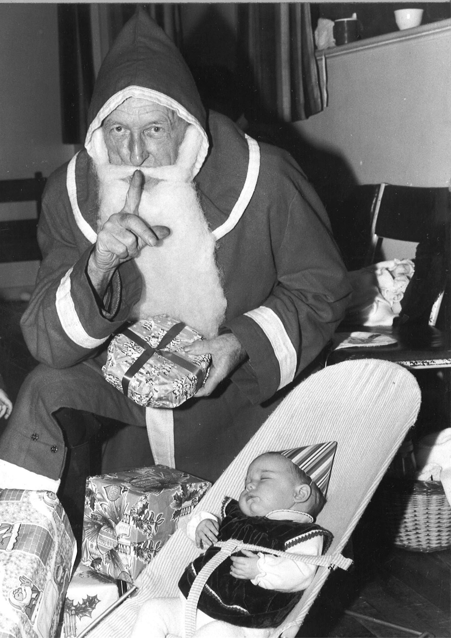 Totally oblivious to Santa during his visit to the Mothers' and Toddlers' group party at Torphins is Michelle Duguid. 1983. 