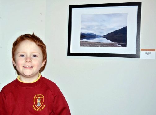 Christopher McAuley-Paton, 4, beside his photo of Loch Lomond he snapped on his mum’s iPhone.