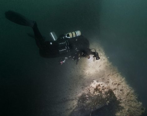 Divers inspect the bow of HMS Vanguard in Scapa Flow