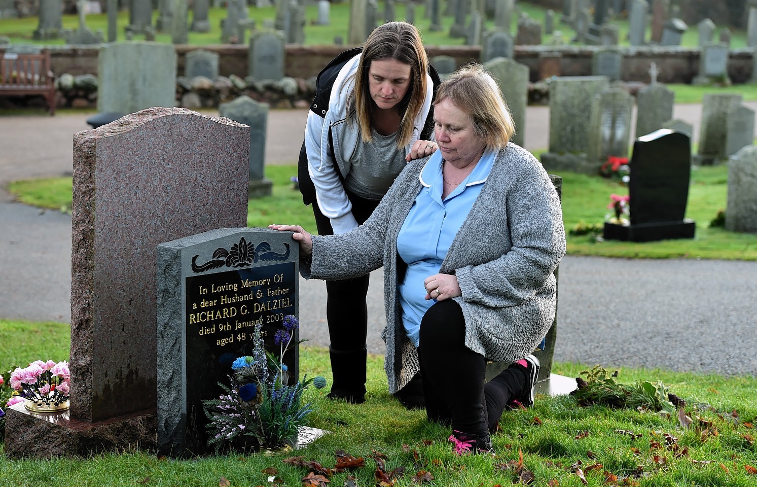 Mary Dalziel (righ) at the grave of her husband Richard with her daughter Lynda Moonan, at the Banchory-Ternan Kirkyard, Banchory. Credit: Kami Thomson.