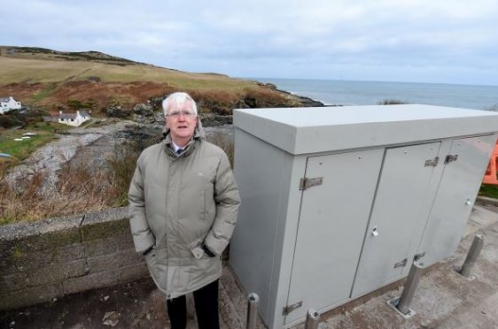 A Scottish Water box getting in the way of the view at Skateraw Road, Newtonhill. In the picture is councillor, Ian Mollison wanting the box to be removed or made smaller. 
Picture by Jim Irvine