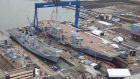 The Royal Navy's new aircraft carrier HMS Queen Elizabeth (right) at Rosyth dockyard