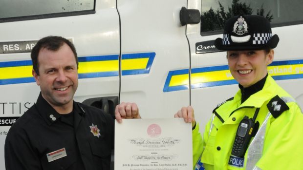 Kevin Smith is presented with his award by Inspector Sheila McDerment (Police Scotland/PA Wire)