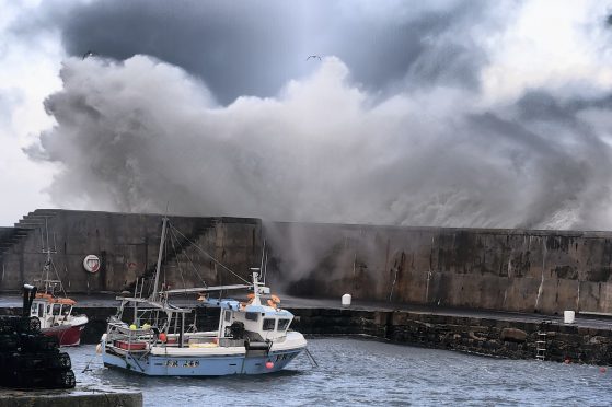 Huge waves at Portsoy harbour. Picture: Kenny Elrick.