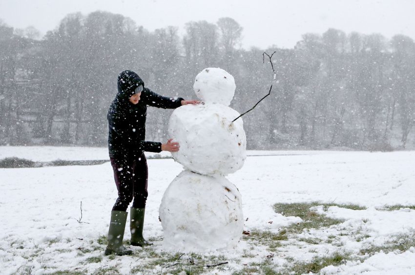 Charlie Boldison building a snowman in Stirling