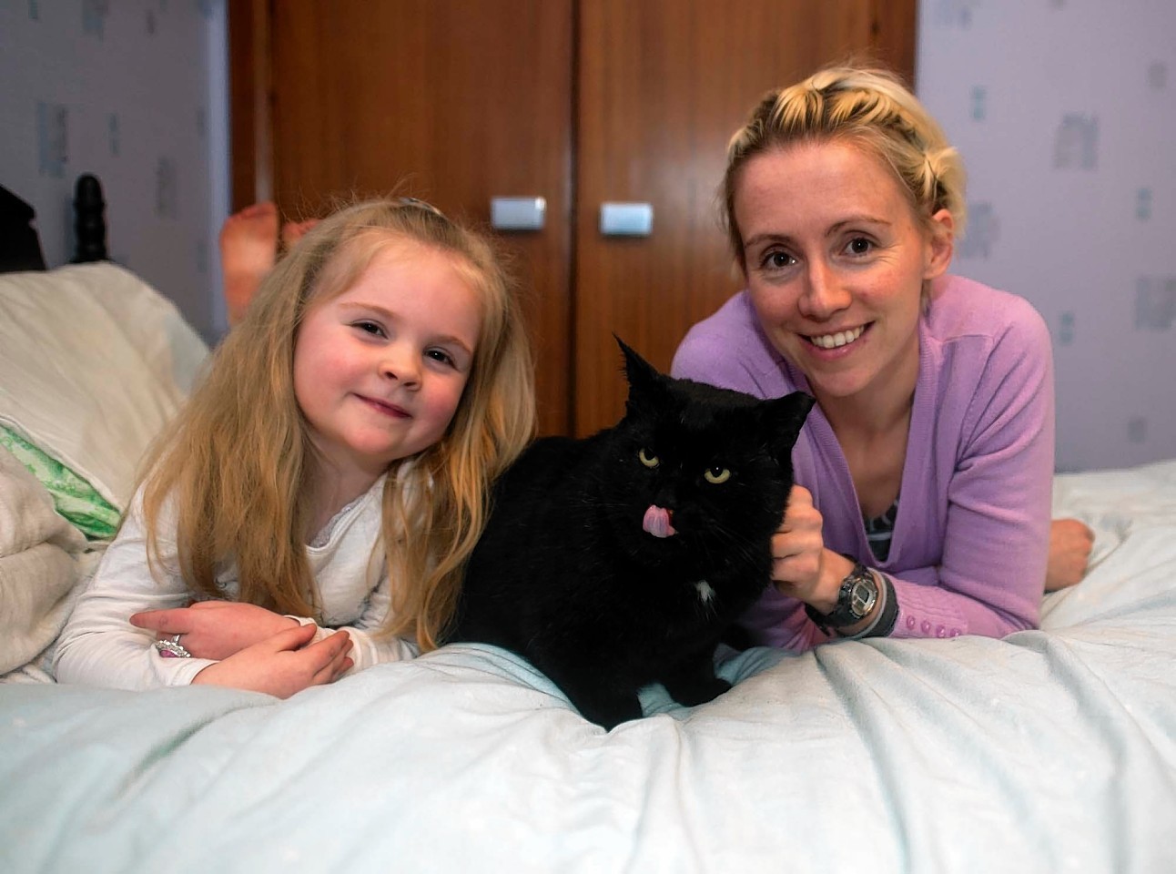 Vet Bethan Fitzgerald with daughter Eira and cat Sam.