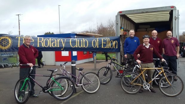Memebers of the Ellon Rotary Club collect unwanted bikes for African children
